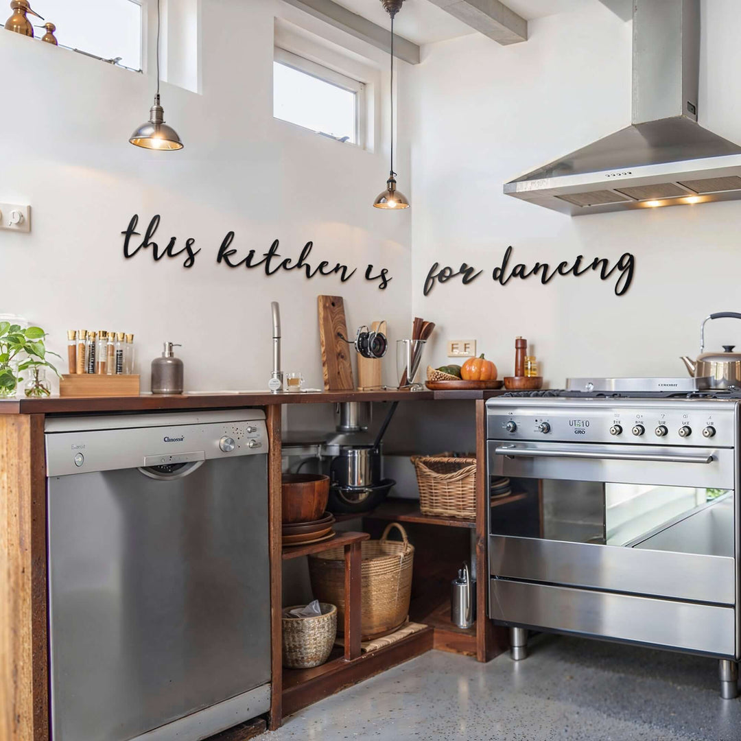 Matte black modern industrial metal wall art reading ‘This Kitchen Is For Dancing’ — five floating 2 mm thick steel pieces in playful script, easy no‑drill wall installation, customizable layout for kitchen décor