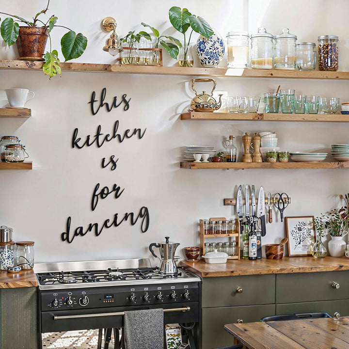 Matte black modern industrial metal wall art reading ‘This Kitchen Is For Dancing’ — five floating 2 mm thick steel pieces in playful script, easy no‑drill wall installation, customizable layout for kitchen décor
