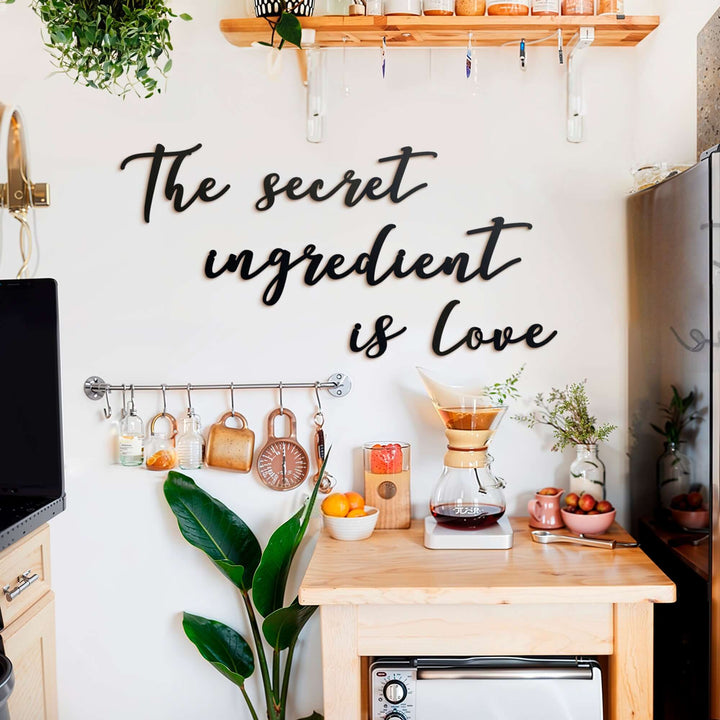 Matte black modern industrial metal wall art reading ‘The Secret Ingredient Is Love’—five 2 mm thick steel pieces, easy no‑drill adhesive installation, customizable layout for kitchen or outdoor décor