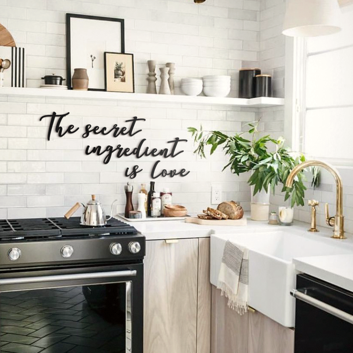Matte black modern industrial metal wall art reading ‘The Secret Ingredient Is Love’—five 2 mm thick steel pieces, easy no‑drill adhesive installation, customizable layout for kitchen or outdoor décor